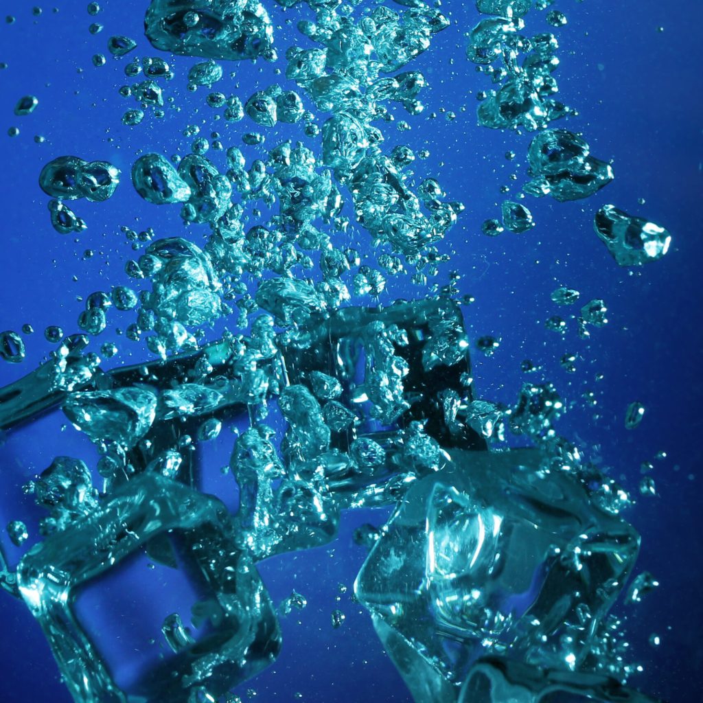 Background of Ice cubes with bubbles underwater